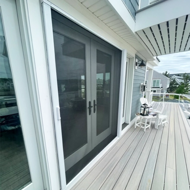 Screen door on the exterior of French doors