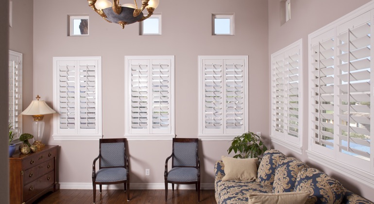 Chic parlor with plantation shutters