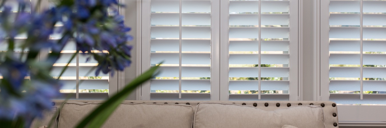 Shutters in a living room with flowers