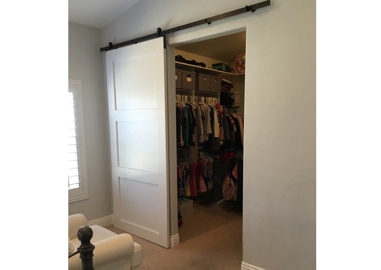 9 Ways To Take Advantage Of Sliding Barn Doors In Austin Sunburst White Barn Door Used As Closet