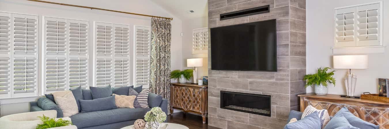 Interior shutters in Spicewood living room with fireplace