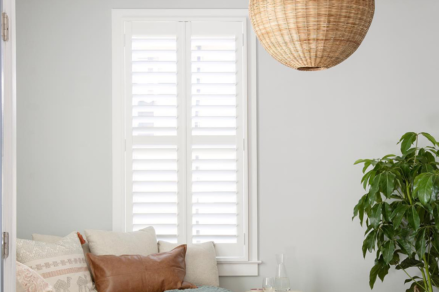 White polywood shutters in a small living room.
