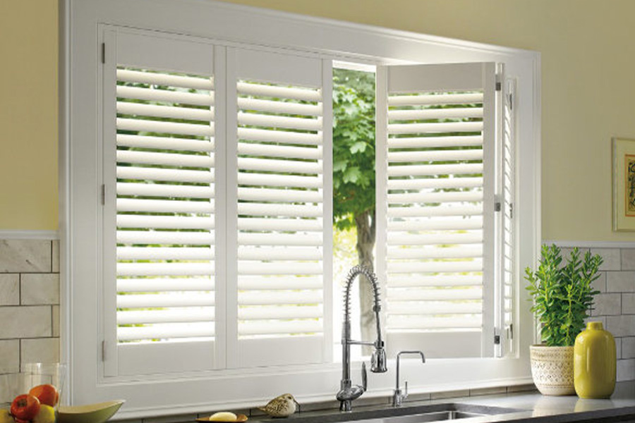 Polywood shutters are built to withstand the test of time in Austin. White Polywood shutters above a kitchen sink.