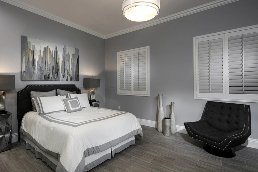 Close your custom Polywood shutters to beat the heat and keep your Austin bedroom cool. White Polywood shutters on bedroom windows