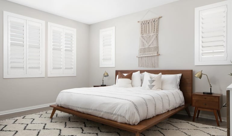 Open shutter louvers will help any Austin room feel larger. Plantation shutters in a model home bedroom.