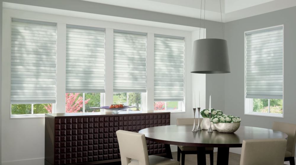 Custom cordless roller shades have a clean look and are appropriate for any room. Cordless motorized shades in a Austin dining room