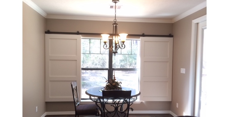 Barn doors open horizontally with slides instead of cords. Austin barn door shutters