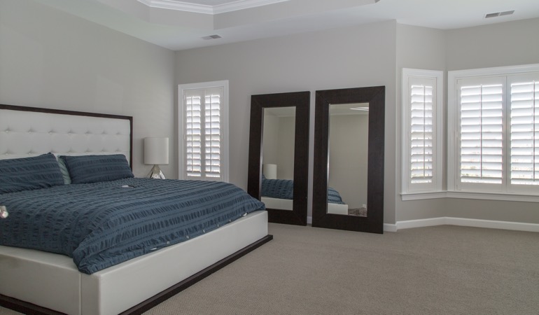 Polywood plantation shutters pairs form with function. Polywood shutters in a minimalist bedroom in Austin.