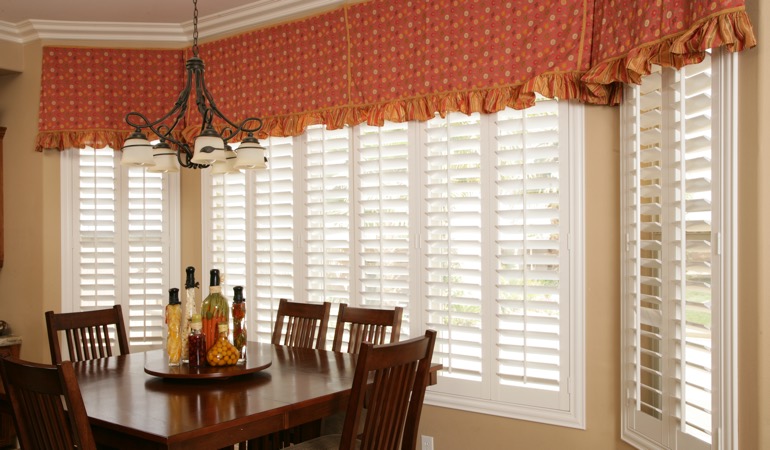 Decorative accents, drapes, and curtains may not offer the simplicity you are going for. White shutters in Austin dining room.