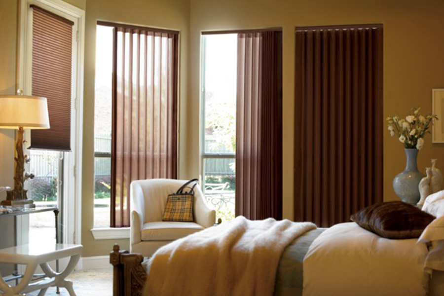Choose durable and high-quality fabric or vinyl vertical blinds in Austin. Maroon fabric vertical blinds inside a bedroom