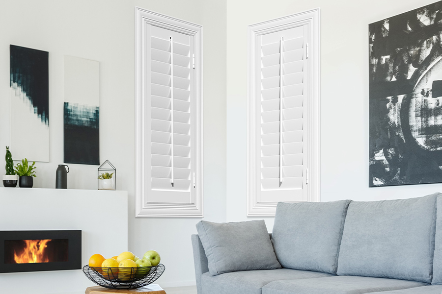 White Polywood shutters add character and class in Austin. White polywood shutters in a corner of a modern living room.