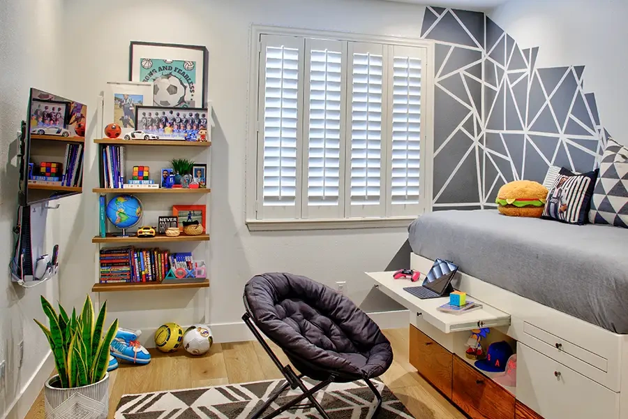 White Polywood shutters make rooms like this play area feel open and brighter. White Polywood shutters in a child's playroom.